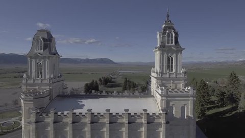 Aerial fly down side view of LDS Mormon Temple in Manti Utah. Shot in flat color profile for color grading. Color graded version also available. 4k footage. Religious temple in rural area.