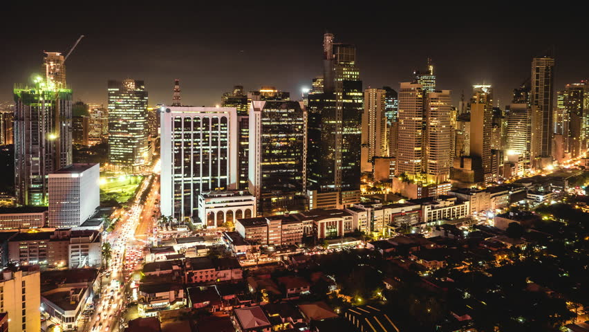 Metro Manila time lapse, looking over Makati city skyline at night in Philippines.
