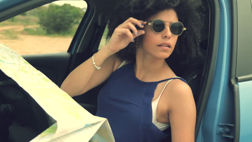 Confused car driver using map to plan trip