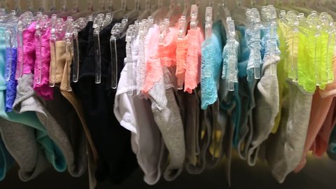 Shop of women's underwear. Women's panties on hangers in a sex store