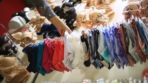 Shop of women's underwear. Women's panties on hangers in a sex store