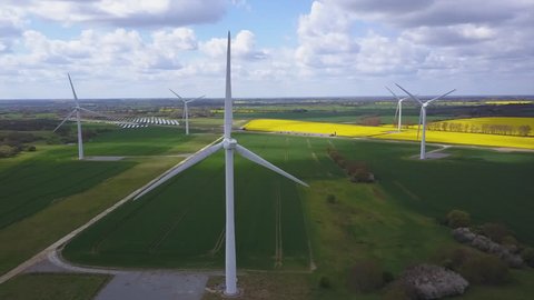 Wind turbines high altitude aerial shot with rape seed fields in background 
