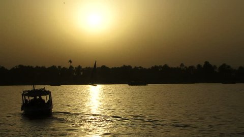 Boat traveling down the nile at sunset.