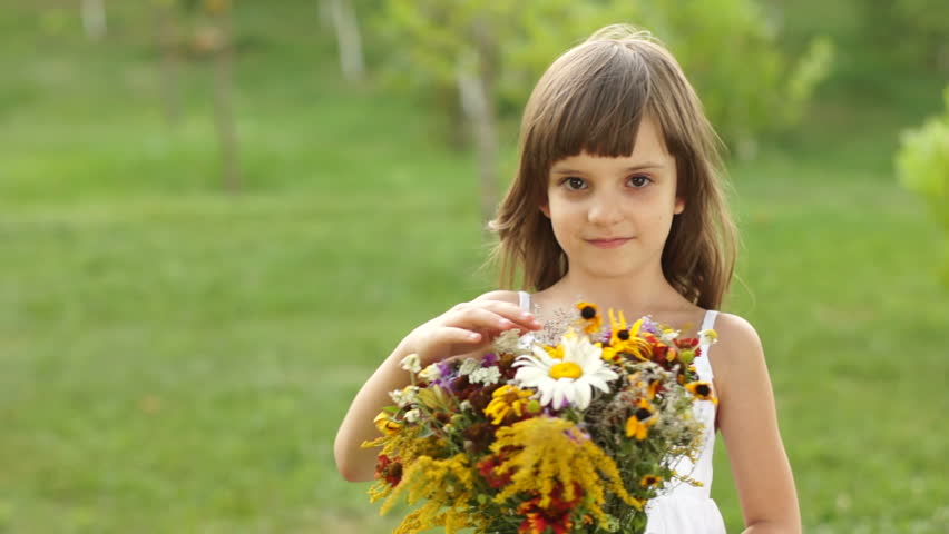 Smiling girl with bouquet of flowers
