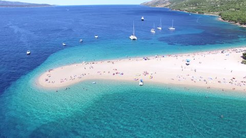 BOL, CROATIA - AUGUST 1, 2014: Aerial view of people swimming and sunbathing on a sandy beach on the island of Brac, Croatia