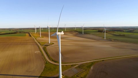 Wind energy farm slow smooth pan shot, aerial view