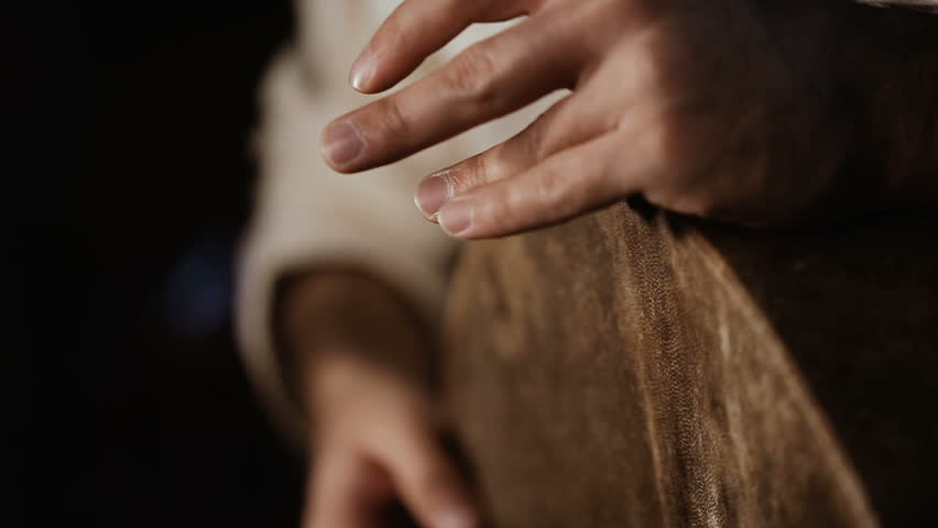 Extremelly close up shot of man's hands drumming out a beat on an arabic percussion drum named Bendir at home. Shot on black background | Shutterstock HD Video #25921889