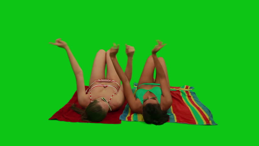 Girls lying on the towel and dancing with their hands