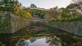4K Day to Night timelapse zoon in motion video of Wakayama Castle and the Ohashi Roka bridge at twilight