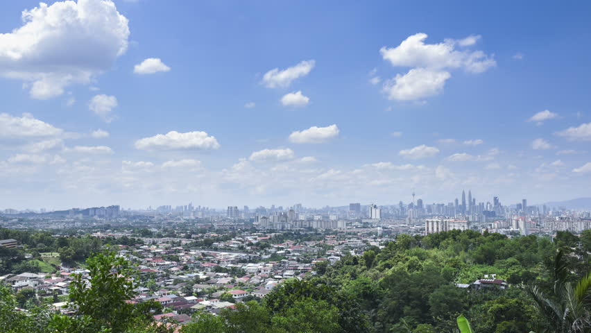 Moving cloud with Kuala Lumpur skyline during windy and hot day.