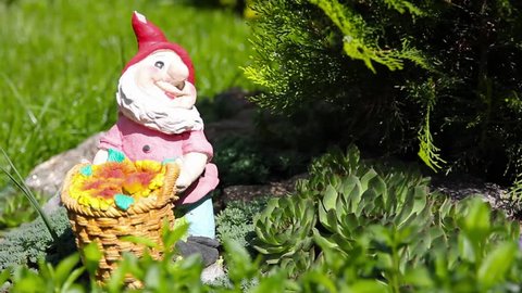 Gnome in a garden holding a basket