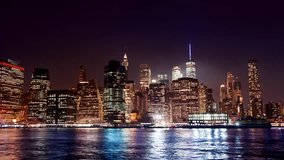 Lower downtown Manhattan in night above the New York Financial District skyscrapers timelapse.