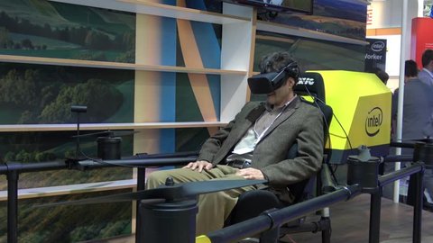 Hannover, Germany - March, 2017: Man in virtual reality headset. Experience the 5G area in virtual reality on Intel stand on exhibition Cebit 2017 in Hannover Messe, Germany
