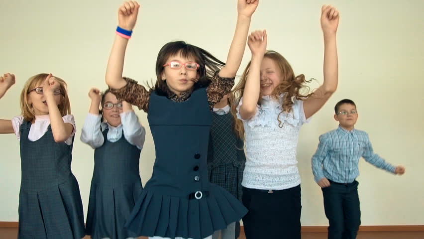 Large group of happy cheerful children jumping and dancing