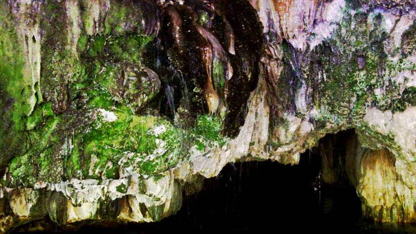 Water flows from a natural spring in a cave formed by an underground river. 