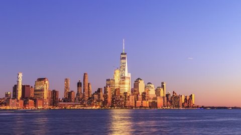 Day to night time lapse of sunset over New York City Manhattan downtown skylines and financial center over Hudson River