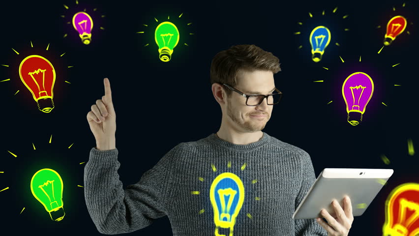 Clever hipster creative man think touch digital tablet ipad gets an idea, which jumps up as symbolic colored cartoon animation shape lamps around him on black background