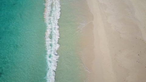 4k footage, still aerial view waves and empty sandy beach from above
