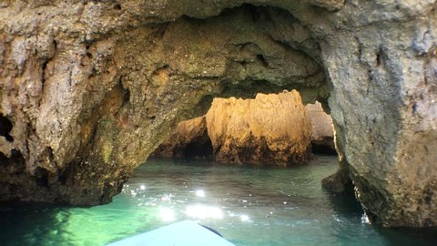 POV Speedboat Ride Inside Rock Caves In Ocean. POV boat scene floating into the ocean going straight to a rock cave