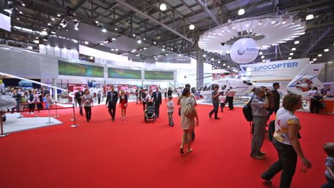 MOSCOW - MAY 21: People consider models of helicopters on International exhibition of helicopter industry of Helirussia in Exhibition center Expo Crocus, on May 21, 2012 in Moscow, Russia