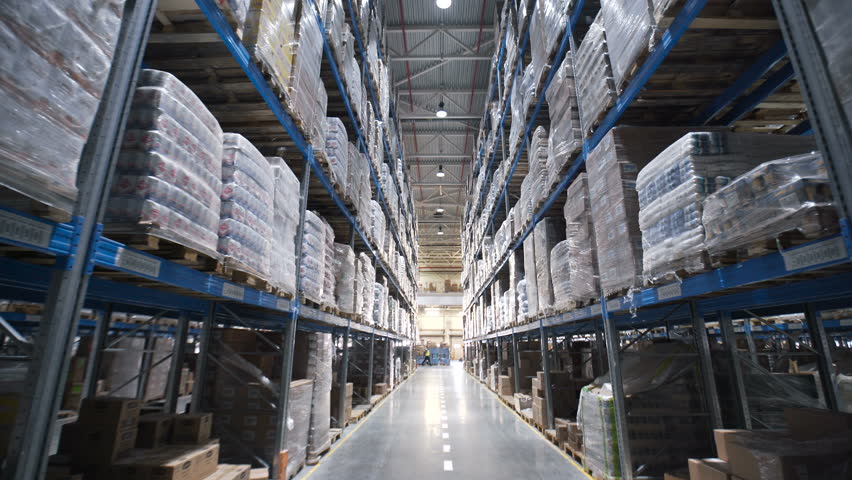 Warehouses large logistics commerce structure with boxes on the shelf. Teamwork male person industry production, using machine work and vehicle, delivering merchandise for transnational export indoors Royalty-Free Stock Footage #25957949