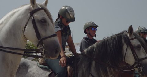 Sanlucar, Spain - August 26, 2016: 4K Guardia Civil on horseback. Guard is stroking horse's mane