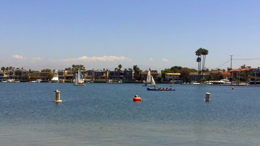 Distant canoes and sailboats ply the waters of Alamitos Bay In Long Beach,