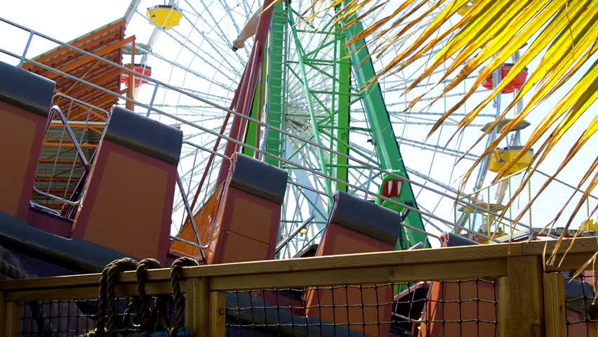 A cross-section of moving amusement park rides on Santa Monica Pier in Santa