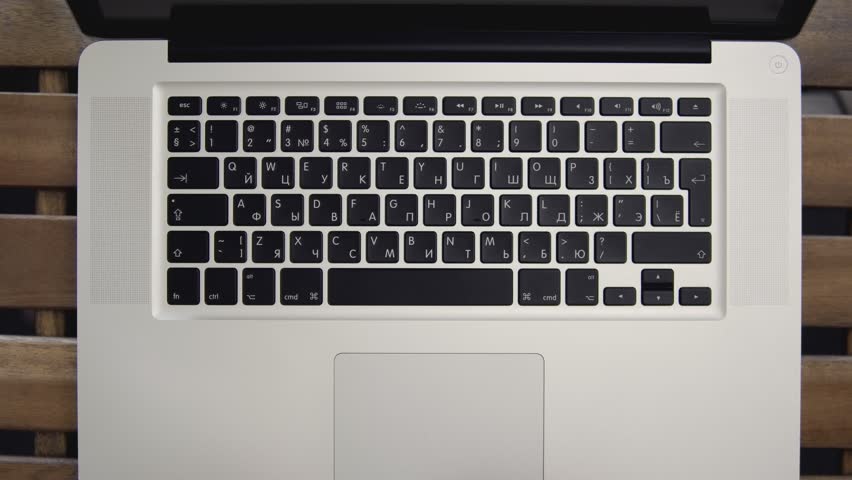 Close up of businessman hands typing on laptop computer on wooden table. Top view. Close up view. 4k shot. Concept of network communications or online shopping