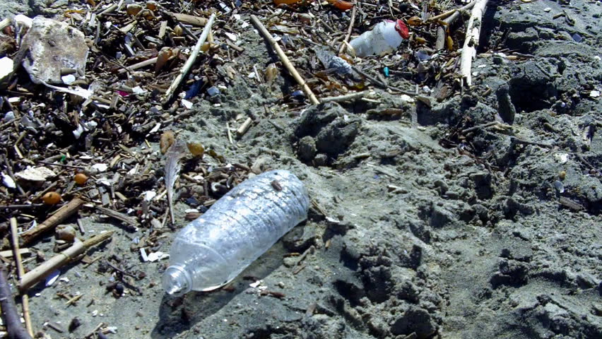 An medium shot of plastic bottle trash on the beach in Southern California. 