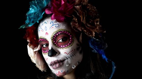 beautiful woman with custom designed candy skull mexican day of the dead face make up. this version has been run through effects to give it intentional video static and distortion