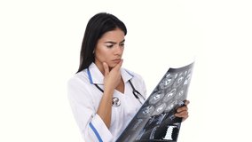 Woman nurse inspecting x-ray image and thinking about diagnosis isolated
