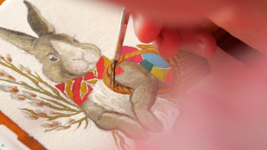 female artist painter painting a picture of a easter bunny