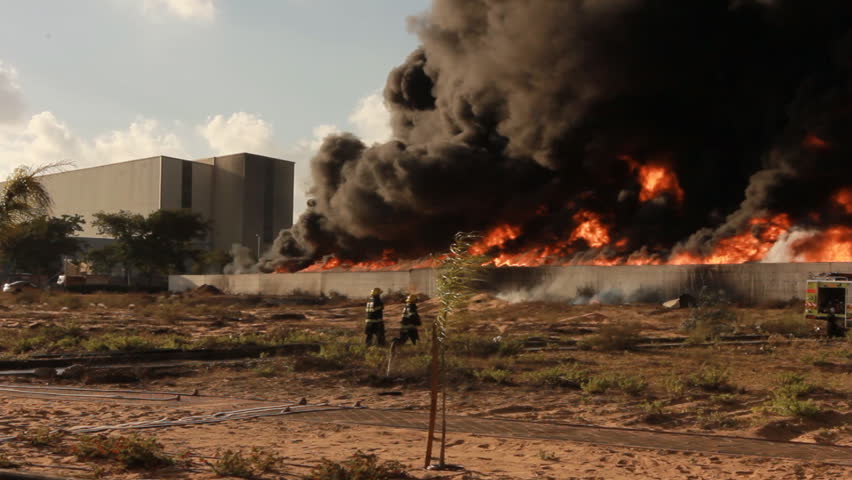 Firefighters battle blaze in packaging industrial factory fire Royalty-Free Stock Footage #25995218