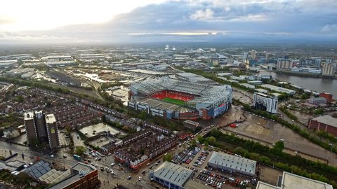 Aerial View of Manchester Cityscape and Manchester United's Iconic Stadium Old Trafford Football Ground with Beautiful Sunset. Old Trafford is a football stadium and the home of Manchester United 4K