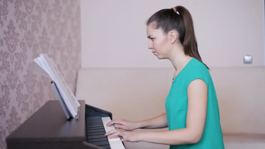 young woman learning to play the piano