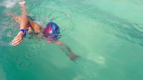 VELINGRAD, BULGARIA - 15 JULY, 2016: Professional swimmer child training crawl freestyle swimming in pool