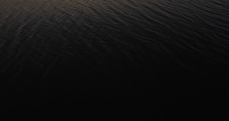 Sunset in Romania over a small lake, aerial