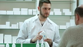 Young pharmacist advicing pills senior man customer at drugstore