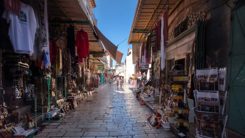 The colorful souk near Holy Sepulchre in the old city of Jerusalem Israel timelapse hyperlapse. Crowd of people passing by on this makret Royalty-Free Stock Footage #26010881
