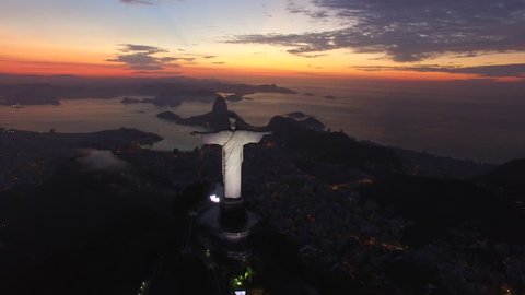 RIO DE JANEIRO, BRAZIL - MARCH 28, 2017
Aerial panoramic view of the Statue of the christ redeemer at Rio de Janeiro early in the morning, during sunrise.  Flying over towards Sugar Loaf mountain. 