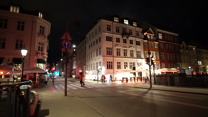 Copenhagen, Denmark - April 2017: Night video of people, tourist walking at Nyhavn landmark area with bars and restaurants