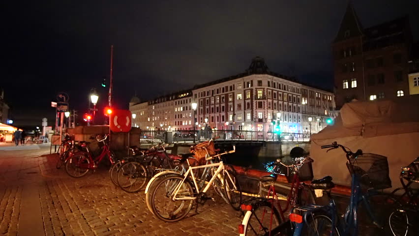 Copenhagen, Denmark - April 2017: Night video of people, tourist walking at Nyhavn landmark area with bars and restaurants