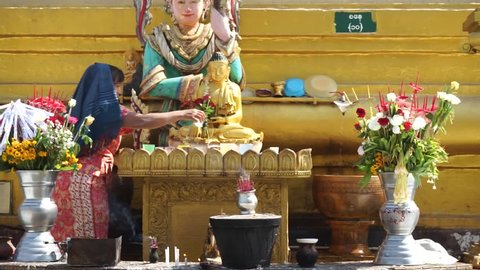 BAGO, MYANMAR - CIRCA APRIL 2017 Woman near Mahazedi Pagoda