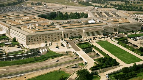 Aerial establishing shot of the pentagon with a small amount of traffic in front of the building.