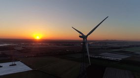 Wind generator in the morning with the rising sun. 4K Aerial video footage in 4K