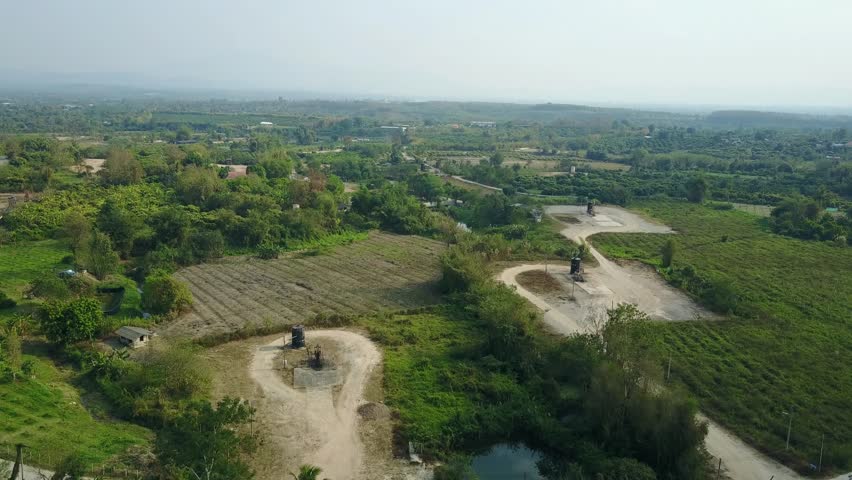 Aerial shot with from a drone. Flying over oil beam pumps (Sucker Rod) in the country side. Oil industry equipment.
