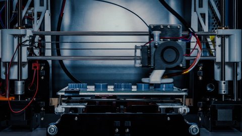 3D diy printer printing plastic mechanical parts in timelapse.An open source diy 3d printer is printing gears and pulleys,using disposable biodegreadable PLA material (filament)