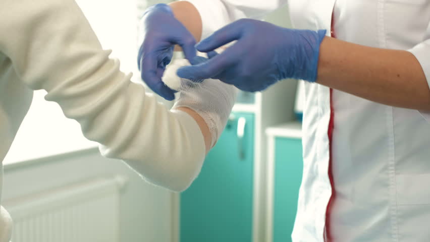 Doctor bandaging patient in hospital. | Shutterstock HD Video #26033723