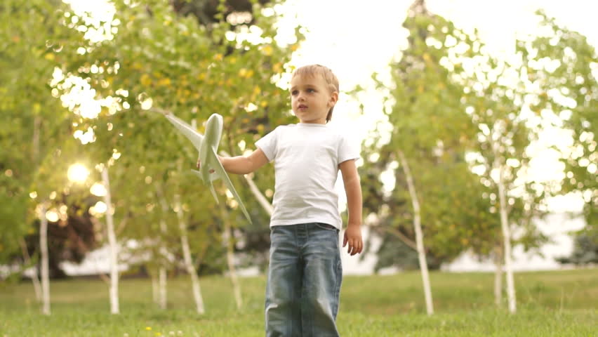 Little boy with model airplane outdoors
